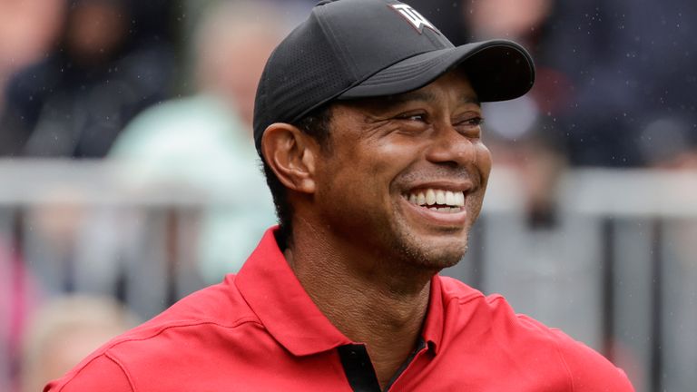 Tiger Woods smiles on 1st tee during the final round of the PNC Championship golf tournament Sunday, Dec. 17, 2023, in Orlando, Fla. (AP Photo/Kevin Kolczynski)