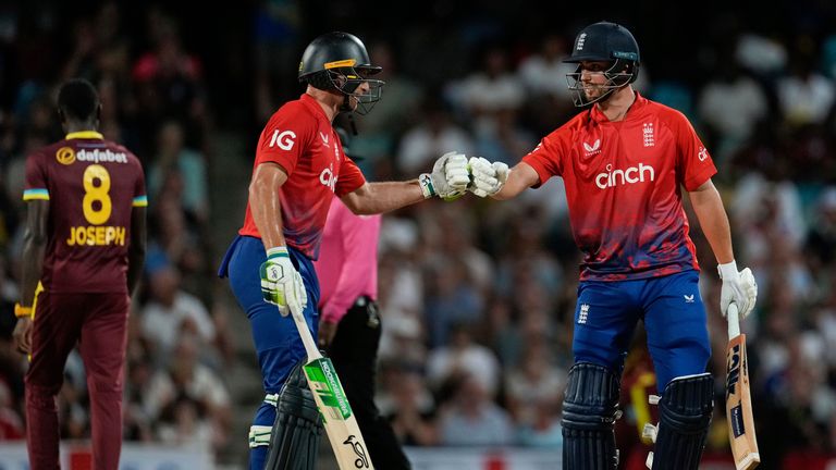 England's Will Jacks, right, celebrates with captain Jos Buttler after hitting a six off Alzarri Joseph