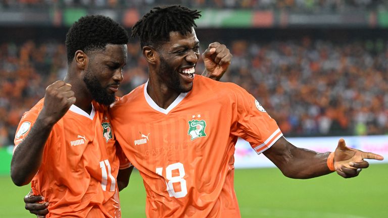 Ivory Coast's forward #11 Jean Philippe Nils Stephan Krasso celebrates with Ivory Coast's midfielder #18 Ibrahim Sangare after scoring his team's second goal during the Africa Cup of Nations (CAN) 2024 group A football match between Ivory Coast and Guinea-Bissau at the Alassane Ouattara Olympic Stadium in Ebimpe, Abidjan, on January 13, 2024. (Photo by Issouf SANOGO / AFP)