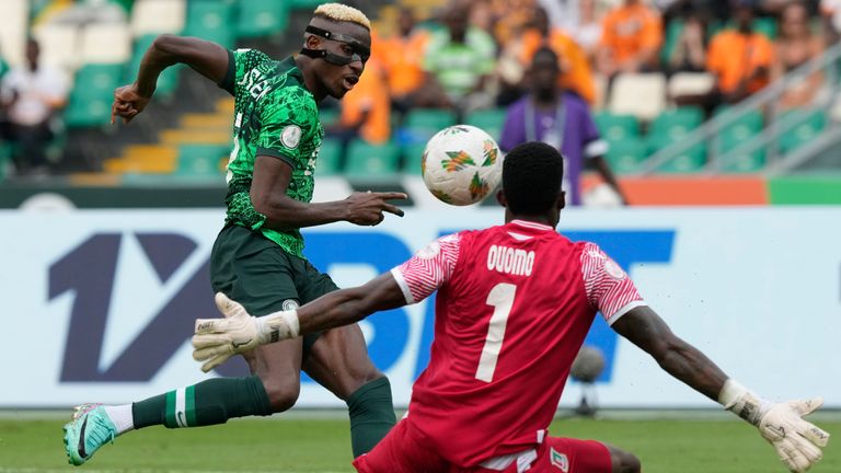 Nigeria's Victor Osimhen, left, kicks the ball against Equatorial Guinea's goalkeeper Jesus Owono during the African Cup of Nations Group A soccer match between Nigeria and Equatorial Guinea's in Abidjan, Ivory Coast, Sunday, Jan. 14, 2024. (AP Photo/Sunday Alamba)