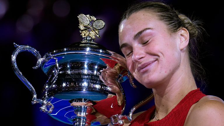 Aryna Sabalenka of Belarus holds the Daphne Akhurst Memorial Cup after defeating Zheng Qinwen of China in the women's singles final at the Australian Open tennis championships at Melbourne Park, Melbourne, Australia, Saturday, Jan. 27, 2024. (AP Photo/Andy Wong)