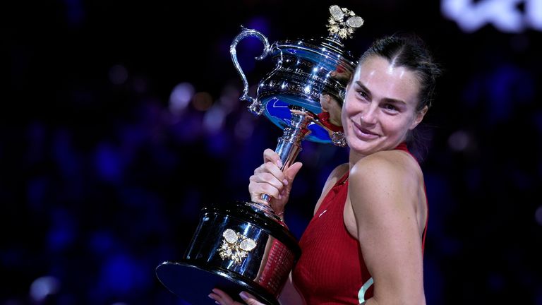 Aryna Sabalenka of Belarus holds the Daphne Akhurst Memorial Trophy after defeating Zheng Qinwen of China in the women's singles final at the Australian Open.
