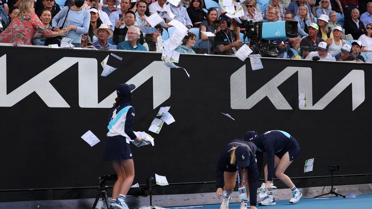 Ball kids clean up paper that was thrown onto Margaret Court Arena by a protestor during the round four singles match between Alexander Zverev of Germany and Cameron Norrie of United Kingdom during the 2024 Australian Open at Melbourne Park on January 22, 2024 in Melbourne, Australia. (Photo by Julian Finney/Getty Images)