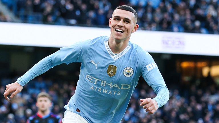 Phil Foden celebrates after scoring against Huddersfield