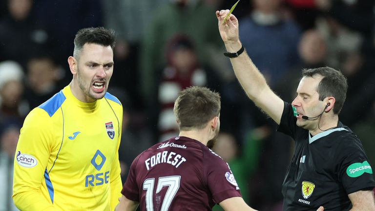 EDINBURGH, SCOTLAND - DECEMBER 30: Referee Alan Muir shows Hearts&#39; Alan Forrest a yellow card for diving during a cinch Premiership match between Heart of Midlothian and Ross County at Tynecastle Park, on December 30, 2023, in Edinburgh, Scotland. (Photo by Roddy Scott / SNS Group)