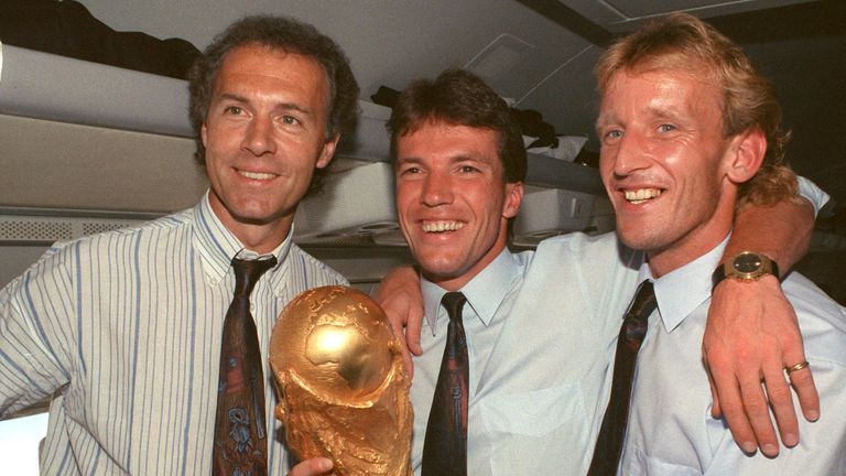 FILED - 09 July 1990, Italy, Rom: On the plane returning from Rome to Frankfurt, former DFB team manager Franz Beckenbauer (l), captain and midfielder Lothar Matth'us (M) and defender Andreas Brehme, who scored the decisive goal, present the World Cup trophy. Franz Beckenbauer is dead. The German soccer legend died on Sunday at the age of 78, his family told the German Press Agency on Monday. Photo by: Wolfgang Eilmes/picture-alliance/dpa/AP Images