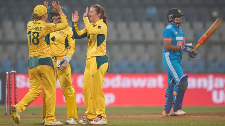 Australia's Georgia Wareham (centre) celebrates the dismissal of India's Richa Ghosh