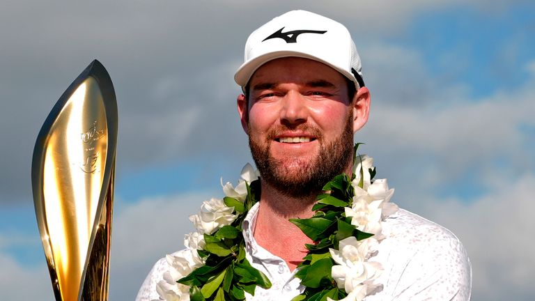 Grayson Murray holds the trophy after winning the Sony Open golf event, Sunday, Jan. 14, 2024, at Waialae Country Club in Honolulu. (AP Photo/Matt York) 
