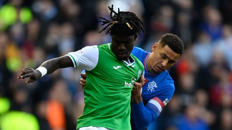 GLASGOW, SCOTLAND - OCTOBER 21: Rangers' James Tavernier and Hibernian's Elie Youan in action during a cinch Premiership match between Rangers and Hibernian at Ibrox Stadium, on October 21, 2023, in Glasgow, Scotland. (Photo by Rob Casey / SNS Group)