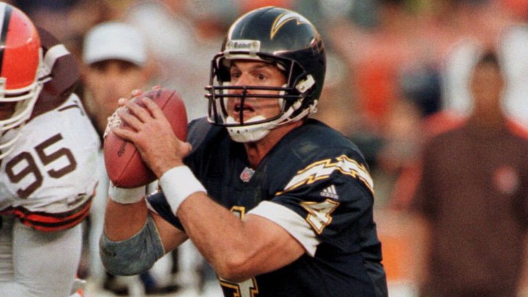 San Diego Charger quarterback Jim Harbaugh scrambles for an eight yard gain during the fourth quarter of the Chargers' 23-10 victory over the Cleveland Browns Sunday, Dec. 5, 1999, in San Diego. The Browns Jamir Miller (95) is in pursuit. (AP Photo/Lenny Ignelzi)
