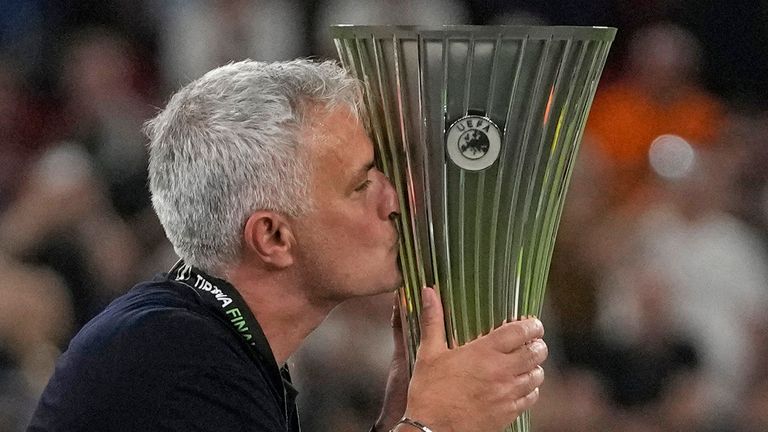FILE - Roma's head coach Jose Mourinho, right, kisses the trophy after winning the Europa Conference League final soccer match between AS Roma and Feyenoord at National Arena in Tirana, Albania, Wednesday, May 25, 2022. Roma has announced on Tuesday, Jan. 16, 2024 that Jos.. Mourinho is leaving the club ...with immediate effect.... The Portuguese coach led the Giallorossi to the UEFA Conference League title in his first season. (AP Photo/Thanassis Stavrakis, File)