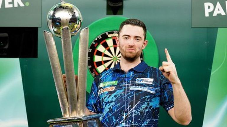 Luke Humphries celebrates with his trophy after beating Luke Littler in the final of the Paddy Power World Darts Championship at Alexandra Palace, London. Picture date: Wednesday January 3, 2024.