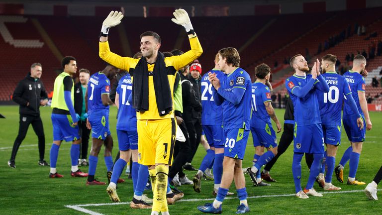 Grimsby's goalkeeper Max Crocombe celebrates after winning the English FA Cup fifth round soccer match between Southampton and Grimsby Town at St Mary's Stadium in Southampton, England Wednesday, March 1, 2023. Grimsby Town won 2-1. (AP Photo/David Cliff)