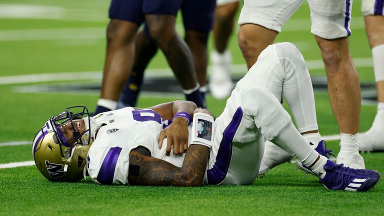 Washington Huskies quarterback Michael Penix Jr. (9) lays on the field after being injured in the fourth quarter (Photo by Joe Robbins/Icon Sportswire) (Icon Sportswire via AP Images)
