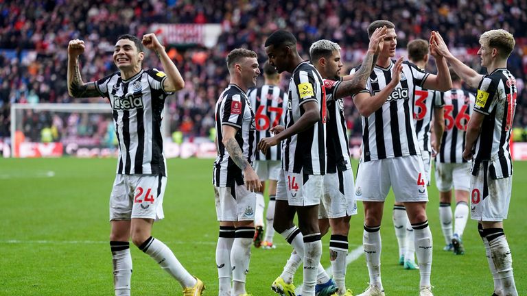 Newcastle players celebrate their third goal