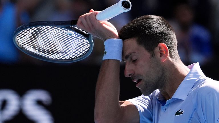 Novak Djokovic of Serbia wipes the sweat from his face during his semifinal against Jannik Sinner of Italy at the Australian Open tennis championships at Melbourne Park, Melbourne, Australia, Friday, Jan. 26, 2024. (AP Photo/Andy Wong)