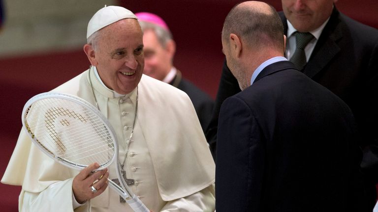 Pope Francis is presented with a tennis racket by the President of the Italian Tennis Federation Angelo Binaghi, right, during an audience with athletes in the Paul VI hall at the Vatican, Friday, May 8, 2015. Pope Francis congratulated Italy on Monday, Jan. 29, 2024, after tennis player Jannik Sinner became the country's first man to win a Grand Slam singles title, the Australian Open, in nearly a half century. (AP Photo/Alessandra Tarantino, File)