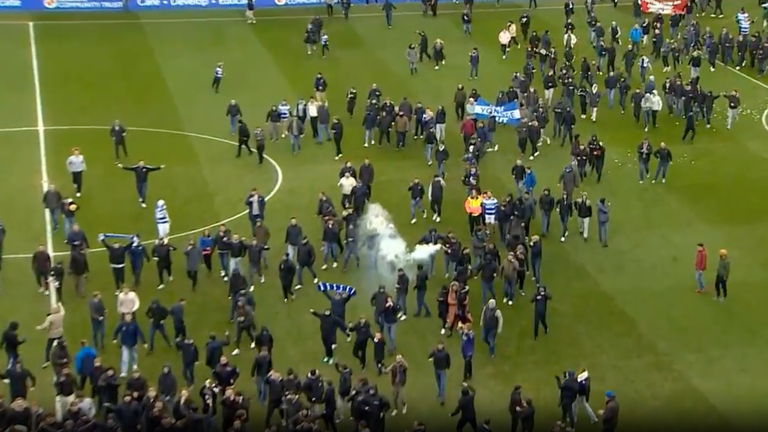 Reading fans walk onto the pitch in protest against the club ownership of Dai Yongge