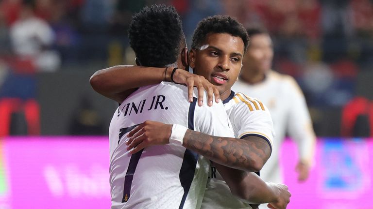 Real Madrid's Brazilian forward #07 Vinicius Junior congratulates teammate Brazilian forward #11 Rodrygo after the latter scored their fourth goal during the Spanish Super Cup final football match between Real Madrid and Barcelona at the Al-Awwal Park Stadium in Riyadh, on January 14, 2024. (Photo by Fayez NURELDINE / AFP)