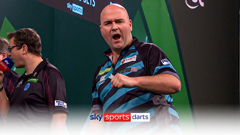 Rob Cross celebrates winning a leg against Chris Dobey