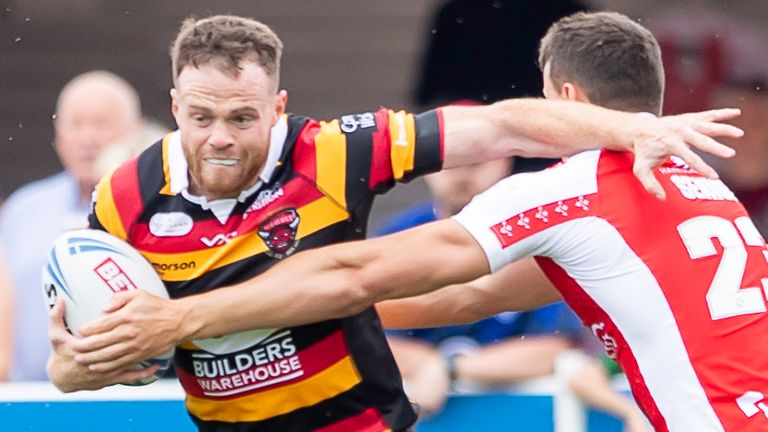 Salford&#39;s Joe Burgess fends off Hull KR&#39;s Louis Senior