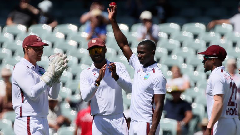 West Indies' Shamar Joseph, second right, holds up the ball after taking 5 wickets against Australia on the second day of their cricket test match in Adelaide, Australia, Thursday, Jan. 18, 2024. (AP Photo/James Elsby)