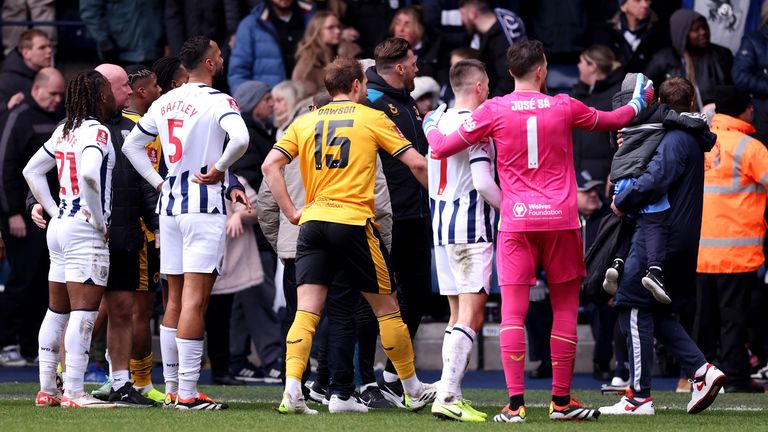 Players from both teams look on following disturbances in the crowd at The Hawthorns