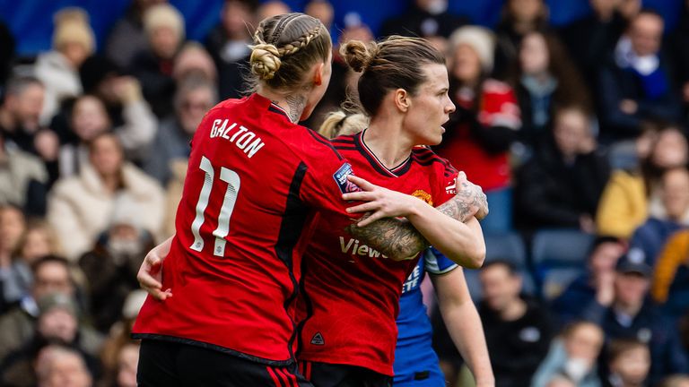 Hayley Ladd is congratulated by Leah Galton after pulling a goal back for Manchester United at Stamford Bridge