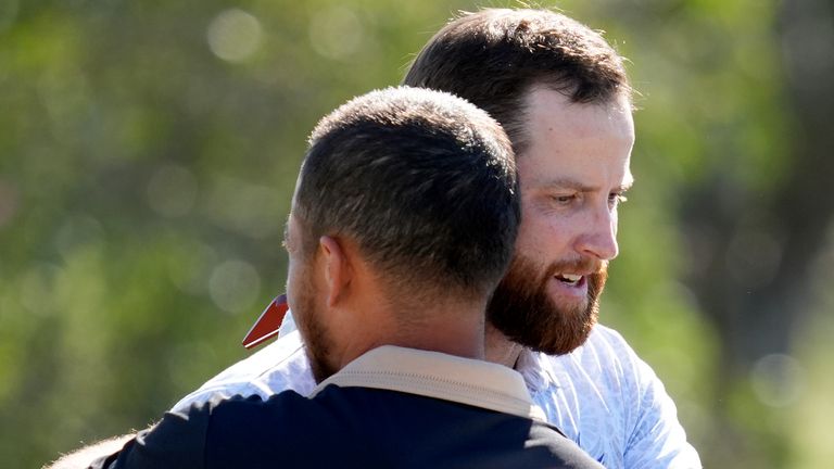 Chris Kirk embraces Xander Schauffele after the final round of The Sentry golf event, Sunday, Jan. 7, 2024, at Kapalua Plantation Course in Kapalua, Hawaii. (AP Photo/Matt York)