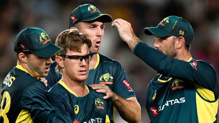 Australian bowler Adam Zampa is congratulated by teammates after taking the wicket of New Zealand's Glenn Phillips during the T20 cricket international between Australia and New Zealand at Eden Park in Auckland, New Zealand, Friday, Feb. 23, 2024. (Andrew Cornaga/Photosport via AP)