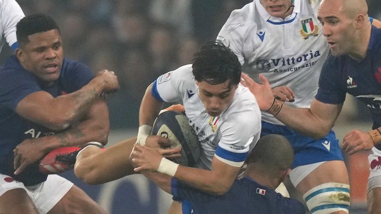 Italy's Ange Capuozzo is tackled by France's Gael Fickou during the Six Nations rugby union international between France and Italy at the Pierre Mauroy stadium in Villeneuve d'Ascq, northern France, Sunday, Feb. 25, 2024. (AP Photo/Lewis Joly)