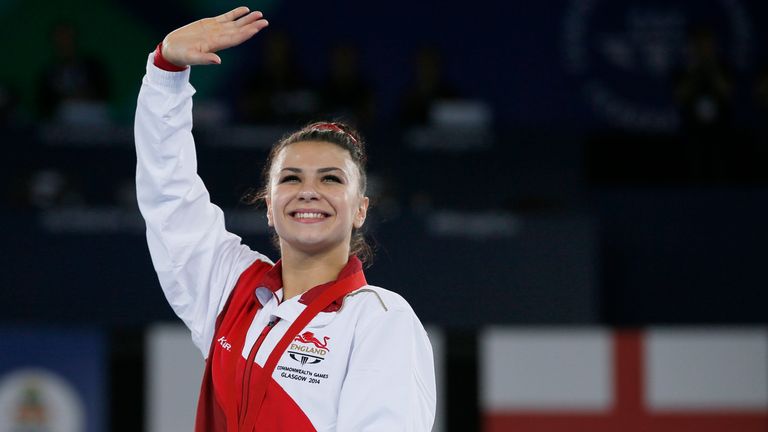 Claudia Fragapane of England waves to the crowd wearing her gold medal for winning the women's individual floor competition, during the medal ceremony at the Commonwealth Games Glasgow 2014, in Glasgow, Scotland, Friday, Aug. 1, 2014.  (AP Photo/Alastair Grant)