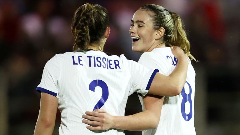 Grace Clinton is congratulated by Maya Le Tissier after scoring a debut goal for England
