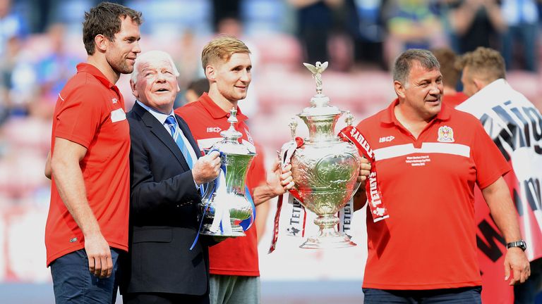 Wigan Athletic Chairman Dave Whelan (2nd left) holds the FA Cup with Wigan Warriors Pat Richards (left) Sam Tomkins and head coach Shaun Wane holding the Challenge Cup, during the Sky Bet Football League Championship match at the DW Stadium, Wigan. PRESS ASSOCIATION Photo. Picture date: Sunday August 25, 2013. See PA story SOCCER Wigan. Photo credit should read: Martin Rickett/PA Wire. RESTRICTIONS: Editorial use only. Maximum 45 images during a match