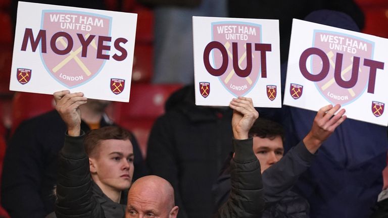 West Ham fans hold up 'Moyes Out' signs during the Premier League match at the City Ground, Nottingham. Picture date: Saturday February 17, 2024.