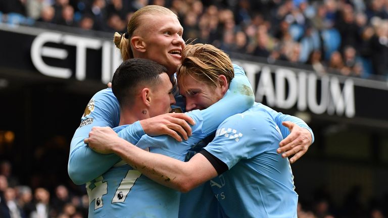 Erling Haaland celebrates with Kevin De Bruyne and Phil Foden after scoring his side's second goal