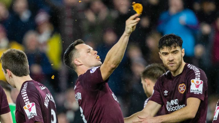 In his celebration, Lawrence Shankland took a bite of a pie that was thrown at him during the Edinburgh derby