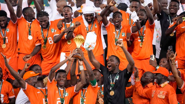 Ivory Coast players celebrate with the trophy