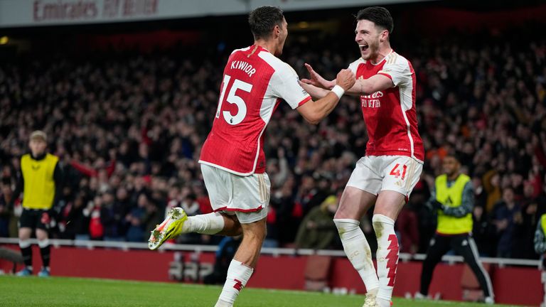 Jakub Kiwior celebrates Arsenal's fourth goal with Declan Rice