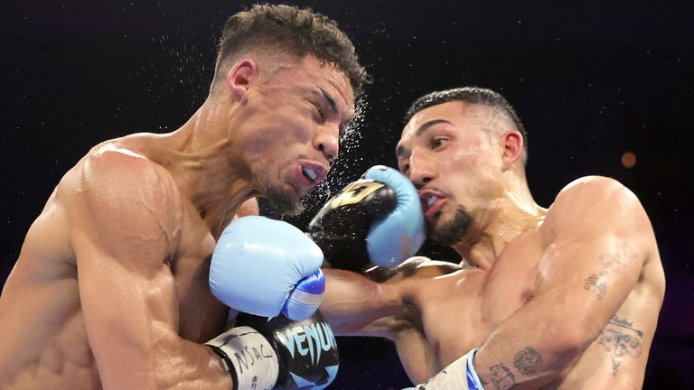 Jamaine Ortiz, left, takes a punch from WBO junior welterweight champion Teofimo Lopez during a boxing bout Thursday, Feb. 8, 2024, in Las Vegas. Lopez retained his title with a unanimous decision. (Steve Marcus/Las Vegas Sun via AP)