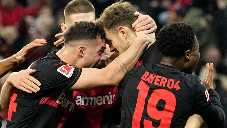 Leverkusen's Josip Stanisic celebrates with team-mates after scoring his side's opening goal