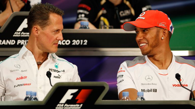 Mercedes Grand Prix driver Michael Schumacher of Germany, left, McLaren Mercedes driver Lewis Hamilton of Britain during a news conference at the Monaco racetrack, in Monaco, Wednesday, May 23, 2012. The Formula one race will be held on Sunday. (AP Photo/Luca Bruno)