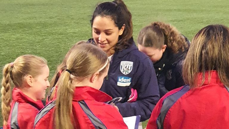 Mariam Mahmood signs autographs after West Brom's win against Derby County