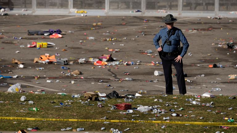 A law enforcement officer looks around the scene after an incident following the Kansas City Chiefs victory parade in Kansas City, Mo., Wednesday, Feb. 14, 2024. The Chiefs defeated the San Francisco 49ers Sunday in the NFL Super Bowl 58 football game. (AP Photo/Charlie Riedel)
