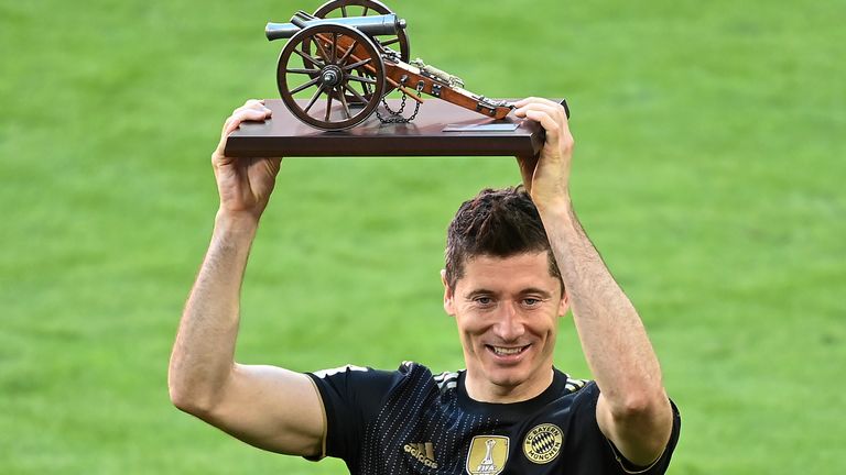 Bayern's Robert Lewandowski holds a trophy of the best scorer of the season after winning the Bundesliga title after the German Bundesliga soccer match between Bayern Munich and FC Augsburg at the Allianz Arena stadium in Munich, Germany, Saturday, May 22, 2021. (Sven Hoppe, Pool via AP)