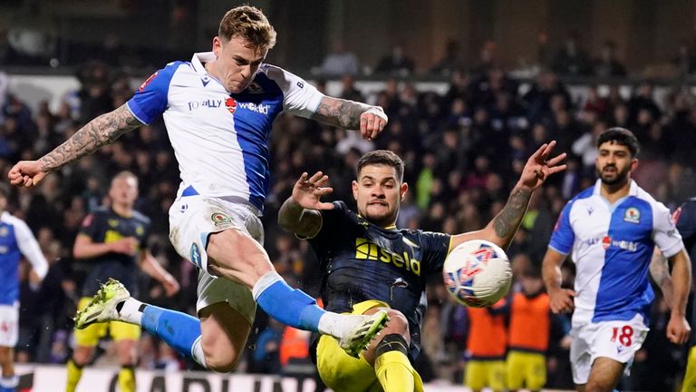 Blackburn's Sammie Szmodics, left, scores his side's opening goal during the English FA Cup fifth round soccer match between Blackburn Rovers and Newcastle, at Ewood Park stadium, in Blackburn, Tuesday, Feb. 27, 2024. (AP Photo/Dave Thompson)