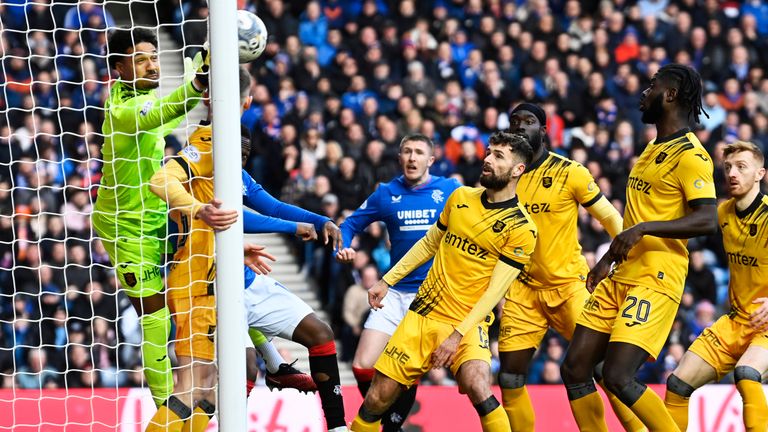 Livingston goalkeeper Shama George punches clear from a James Tavernier corner