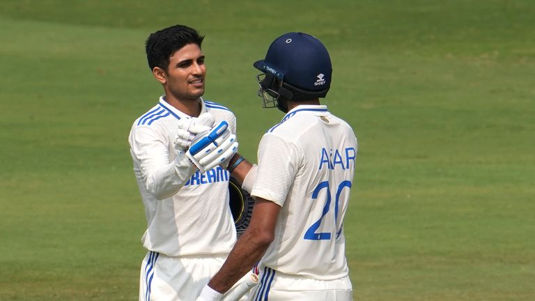 India's Shubman Gill celebrates his century with teammate Axar Patel 