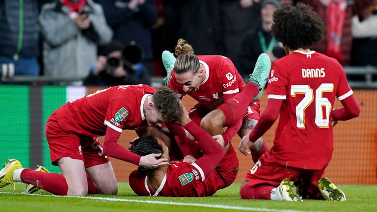 Virgil van Dijk is mobbed by team-mates after scoring an extra-time winner for Liverpool
