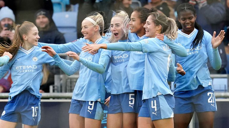 Chloe Kelly is mobbed by her team-mates after doubling Man City's lead over Leicester